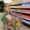 Young girl smiles as she pushes a cart through The Just One Project market.