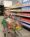 Young girl smiles as she pushes a cart through The Just One Project market.