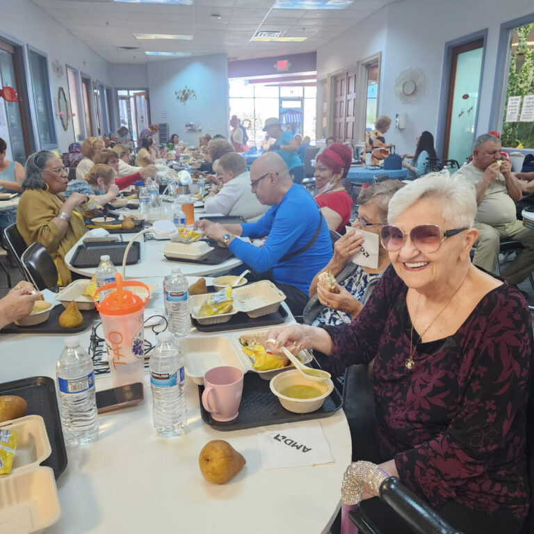 Seniors enjoy a shared meal at a community dining space supported by The Just One Project’s Food Rescue Alliance, highlighting food access, connection, and dignity for aging neighbors.